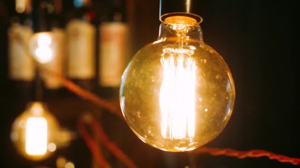 Bright incandescent bulbs hang and shine in row. Electric lights brightly shine - Footage, Video