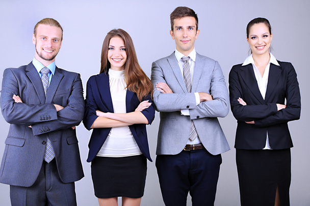 Business team standing in row on grey background - Foto, imagen
