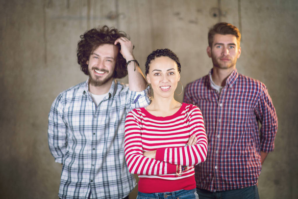 portrait of casual business team in front of a concrete wall - Фото, изображение