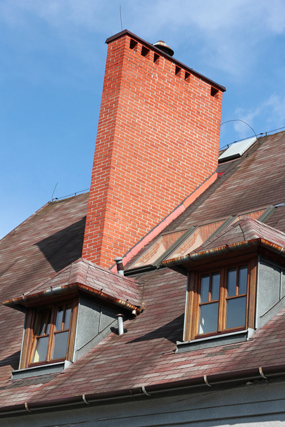 Roof with brick chimney and two vertical windows - Photo, Image