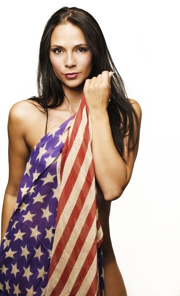 Beautiful woman wrapped in American flag - Фото, изображение