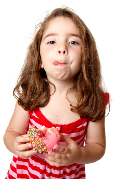 Mädchen essen Donut lecken Lippen - Foto, Bild