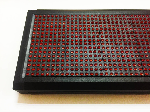 LED module on a white background. Red pixels on the LED module. Components for light advertising. Close-up. - Photo, Image