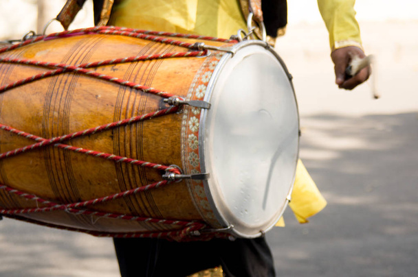 Dhol drummer playing this traditional indian instrument in the street - Photo, Image