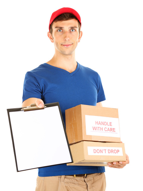 Young delivery man holding parcels and clipboard, isolated on white - Photo, Image