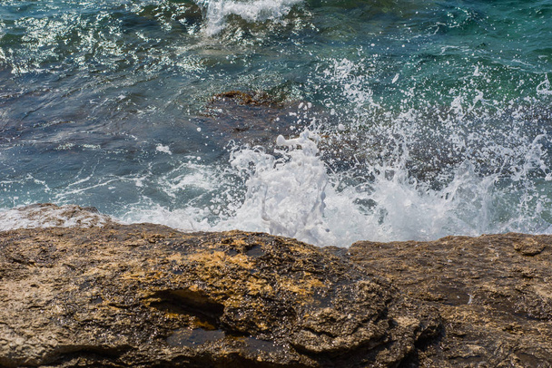 Waves breaking on a stony beach in Murter, Croatia, Dalmatia - Fotoğraf, Görsel