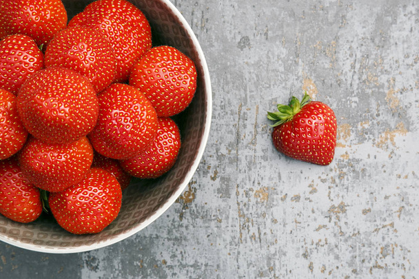 Strawberries in a fruit bowl - directly above flat lay composition. Health eating concept.  - Photo, Image