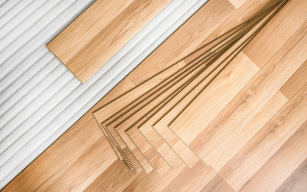 Плитка з ламінованої підлоги з дерев'яним ефектом укладання на білій пінопласт, готовий до установки, вид зверху вниз фото для благоустрою будинку
 - Фото, зображення