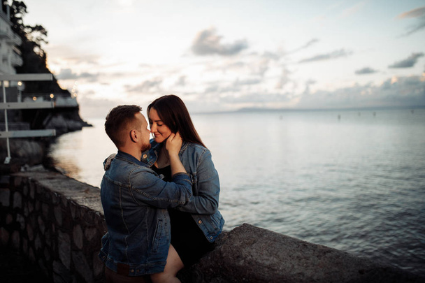 Beautiful young couple posing by sea - Photo, Image