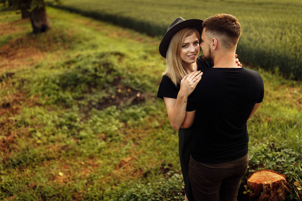 Beautiful young couple hugging outdoors - 写真・画像
