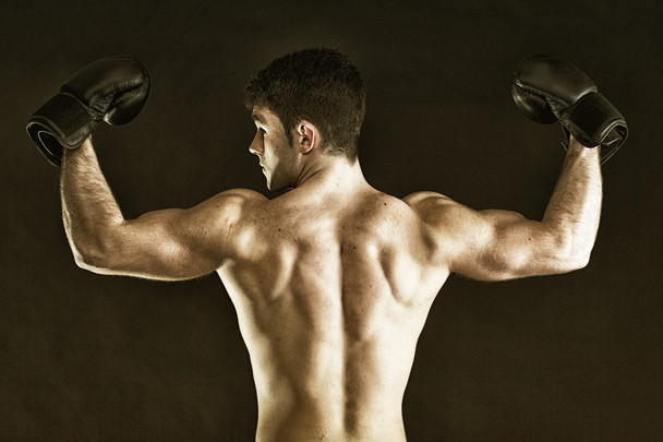 Portrait sportsman boxer in studio dark background - Photo, Image
