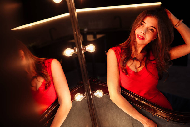 beautiful young   woman posing by mirror - Photo, Image