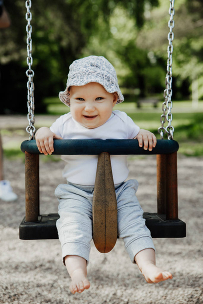 small child is having fun on a swing - Photo, Image