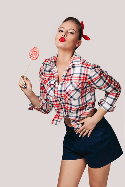 beautiful pin-up woman with lollipop. - 写真・画像