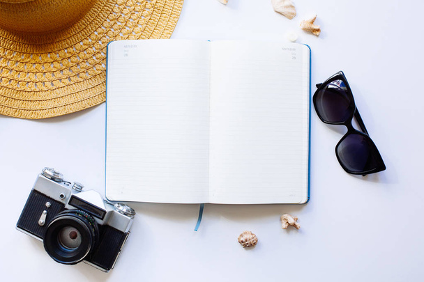 Flat lay design of travel concept with camera, notebook, hat, sh - Foto, imagen