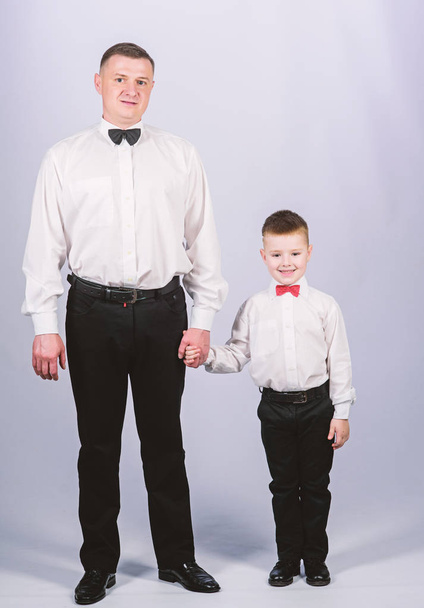 event manager. male fashion. parenting. fathers day. small boy with dad businessman. family day. father and son in formal suit. happy child with father. business meeting party. tuxedo style - Фото, изображение