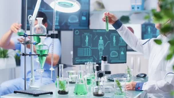 In busy biochemistry laboratory scientist are working - Materiaali, video
