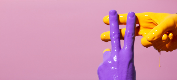 male hands in paint crossed in a hashtag sign on a colored background, creative advertising, social networks concept - Photo, image