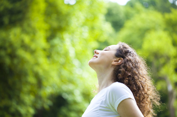 Woman breathing fresh air outdoors in summer - Photo, image