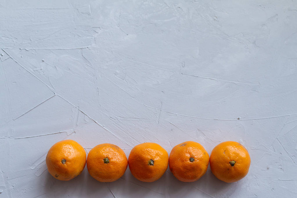 group of mandarins isolated on grey background. Ugly food trend photo with space for text - Foto, afbeelding
