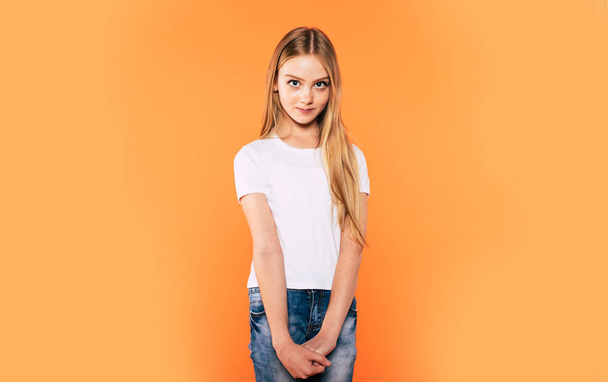 Beautiful little blonde girl in white t-shirt isolated on colorful background - Fotografie, Obrázek