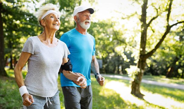 Happy senior people jogging to stay helathy and lose weight - Foto, Imagen