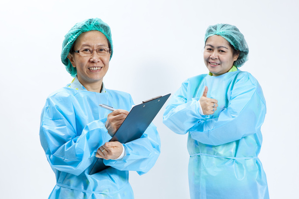 Smiling female medical doctor and nurse with stethoscope and clipboard - Фото, зображення