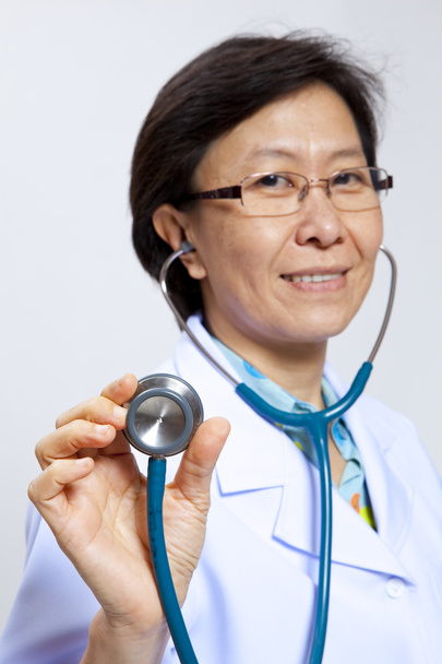 Smiling mature female medical doctor with stethoscope. - Photo, Image
