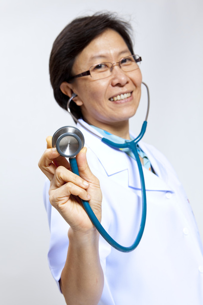 Smiling mature female medical doctor with stethoscope. - Фото, зображення