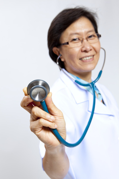 Smiling mature female medical doctor with stethoscope. - Valokuva, kuva