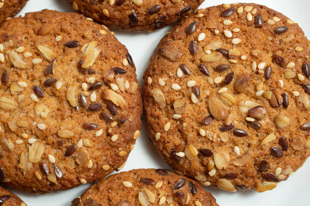Macro foto de galletas de cereales dietéticos bajos en calorías fitness marrón con aspersión de primer plano sobre fondo blanco
 - Foto, imagen