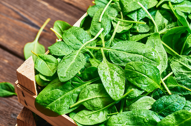 Fresh spinach leaves in a wooden background - Photo, Image