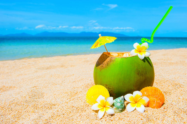 Beautiful beach. Exotic cocktail on the sandy coast. Summer holiday and vacation concept. Tropical beach. - Фото, изображение
