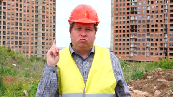 Male builder foreman, worker or architect on construction building site does not agree waving his finger - Felvétel, videó