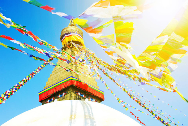 Buddha eyes close up with prayer flags at Bodhnath stupa in Kathmandu valley, Nepal - Φωτογραφία, εικόνα