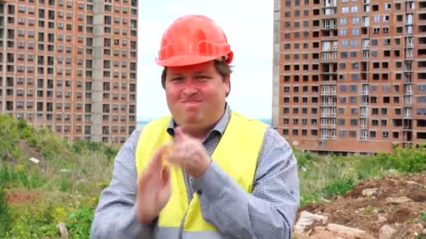 Male builder foreman, worker or architect on construction building site shake hands out of dust - Video