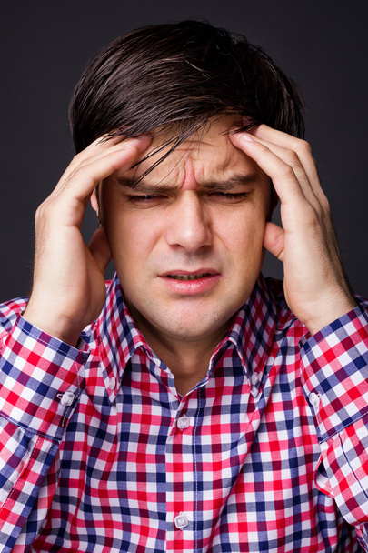 Closeup of a young man with headache - Foto, Imagen