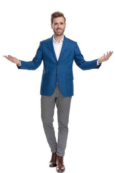 Positive casual man greeting with his hands wide open  - Photo, Image