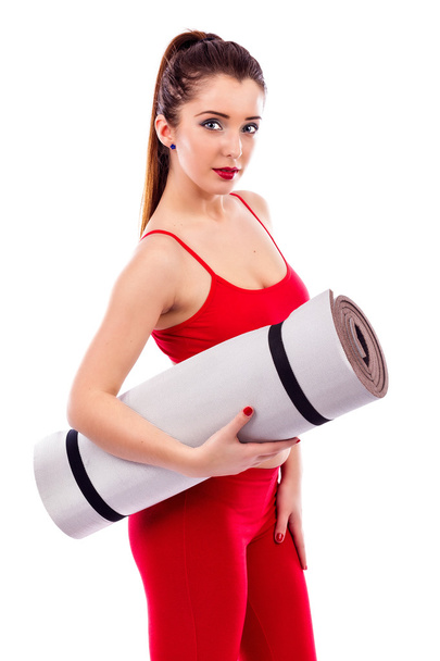 Pretty young woman holding yoga mat - Photo, image