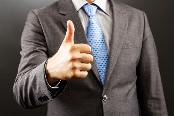 Closeup of a businessman showing thumb up - Foto, afbeelding