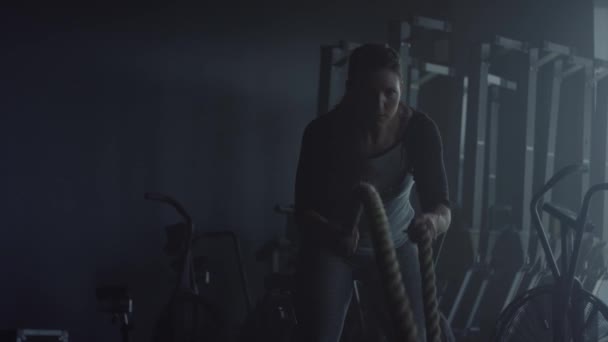 Woman making cross fit training at gym, ropes exercises - Materiaali, video