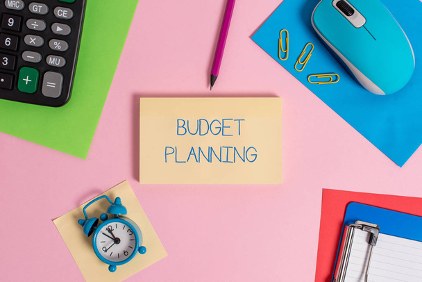 Conceptual hand writing showing Budget Planning. Business photo text The written description about current and future expenses Mouse calculator sheets marker clipboard clock color background. - Photo, Image