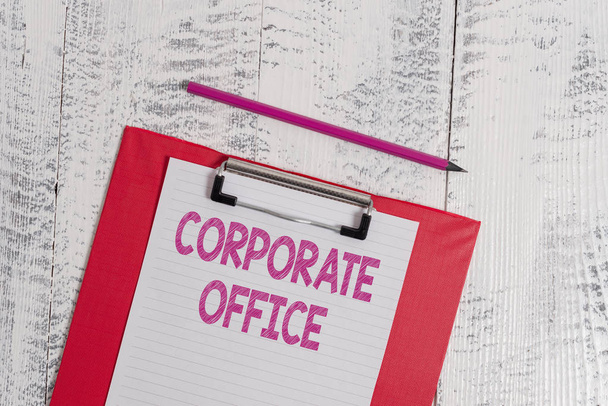 Handwriting text Corporate Office. Concept meaning home department that support primary departments indirectly Colored clipboard blank paper sheet pencil old wooden vintage background. - Photo, Image