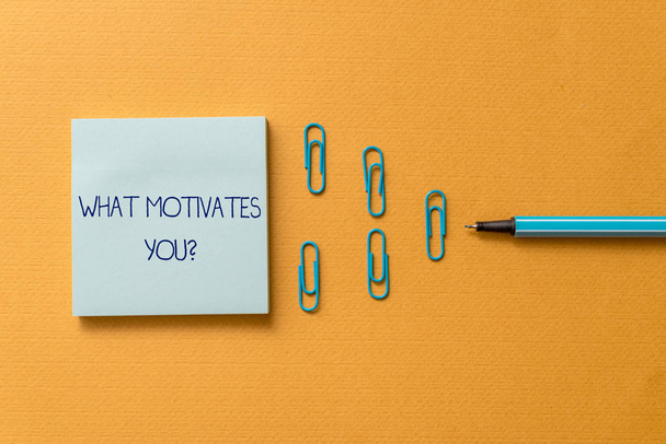 Word writing text What Motivates Youquestion. Business concept for know reasons why you want to wake up each morning Colored blank sticky note clips binders gathered pen trendy cool background. - Photo, Image