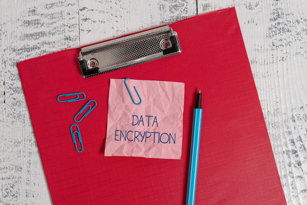 Writing note showing Data Encryption. Business photo showcasing Symmetrickey algorithm for the encrypting electronic data Colored clipboard crushed sticky note clip marker old wooden background. - Photo, Image