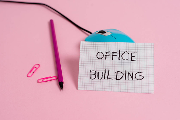 Word writing text Office Building. Business concept for Commercial buildings are used for commercial purposes Wire vintage mouse clips marker squared paper sheet colored background. - Photo, Image
