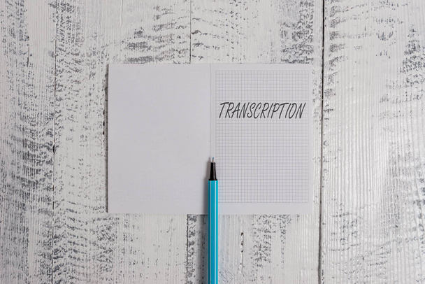 Conceptual hand writing showing Transcription. Business photo showcasing Written or printed version of something Hard copy of audio Square notebook fine highlighter lying on wooden background. - Photo, Image
