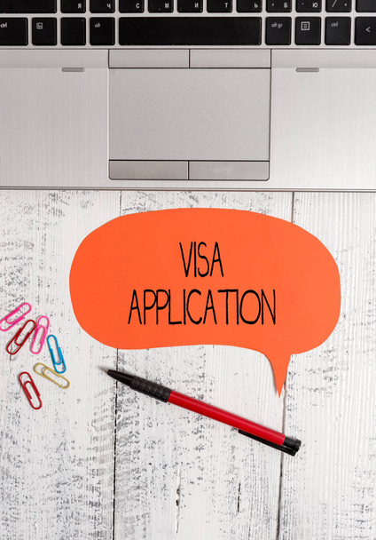 Text sign showing Visa Application. Conceptual photo Form to ask permission travel or live in another country Open laptop blank speech bubble pen ballpoint colored clips vintage wooden. - Photo, Image