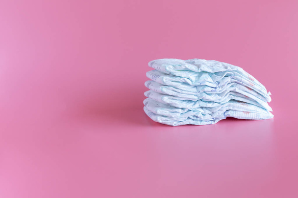 Some baby diapers on a Pink Background - Fotó, kép