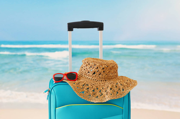 holidays. travel concept. blue suitcase infront of tropical background - Valokuva, kuva